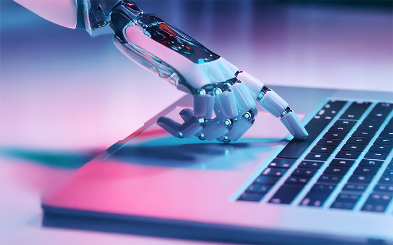 a robot hand typing on a keyboard